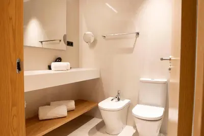a living room with a couch and a kitchen at Goodnight Cádiz Apartments in Cádiz
