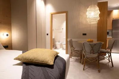 a bedroom with a bed and a table with chairs at Goodnight Cádiz Apartments in Cádiz