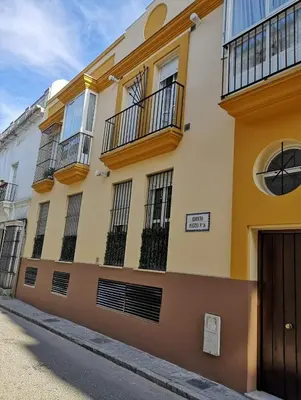 a building with balconies on the side of a street at Apartamento Nao Victoria in Sanlúcar de Barrameda