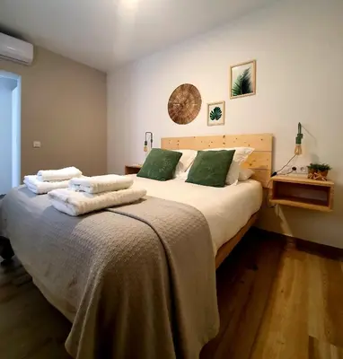 a bedroom with a large bed with towels on it at Cádiz desde el balcón in Cádiz