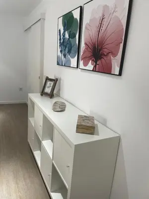 a white desk in a room with paintings on the wall at Apartamento Nebro Estrella, En el Corazón de Cádiz in Cádiz