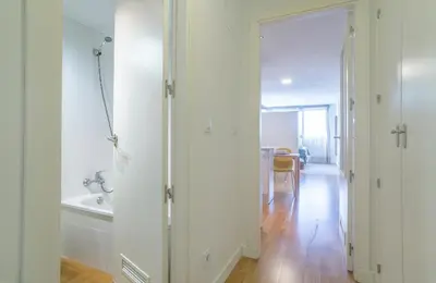 a white bathroom with a tub and a sink at Azvalia - Edificio Parque in El Puerto de Santa María