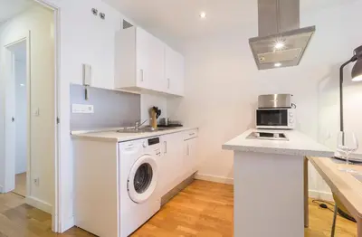 a kitchen with a washing machine and a sink at Azvalia - Edificio Parque in El Puerto de Santa María