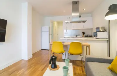 a living room with a couch and two yellow chairs at Azvalia - Edificio Parque in El Puerto de Santa María