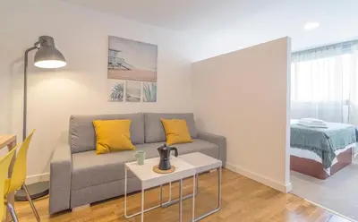 a living room with a couch and a table at Azvalia - Edificio Parque in El Puerto de Santa María