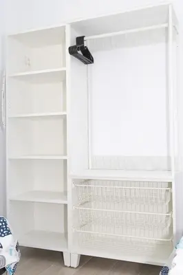 a closet with white shelves and a window at Villa ANDROMEDA in Chiclana de la Frontera