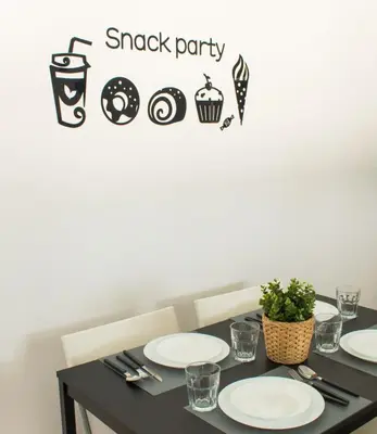 a black table with plates on it with a snack party sign at Villa ANDROMEDA in Chiclana de la Frontera