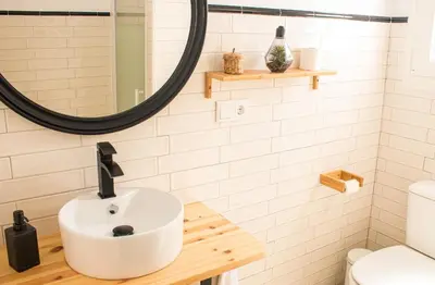 a bathroom with a sink and a mirror at Villa ANDROMEDA in Chiclana de la Frontera
