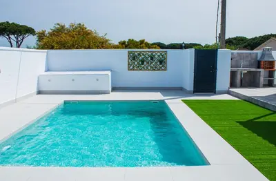 a swimming pool in the middle of a yard at Villa ANDROMEDA in Chiclana de la Frontera