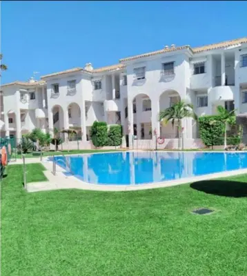 a large apartment building with a large swimming pool at Apartamento vacacional máximo 4 personas in Novo Sancti Petri