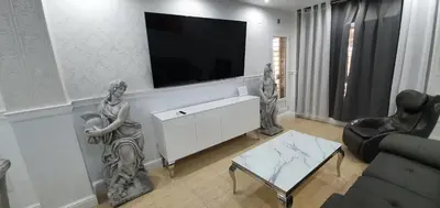 a living room with a flat screen tv on a wall at Oceanum Visum Spa Deluxe in El Trocadero