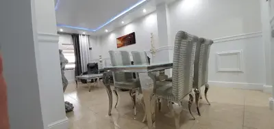 a dining room with a table and green chairs at Oceanum Visum Spa Deluxe in El Trocadero