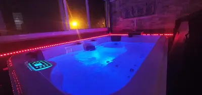 a hot tub with a remote control in it at night at Oceanum Visum Spa Deluxe in El Trocadero