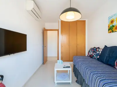 a living room with a couch and a tv at Apartamento LABORT Apartamento Boutique in Cádiz