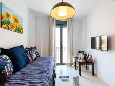 a living room with a couch and a tv at Apartamento LABORT Apartamento Boutique in Cádiz