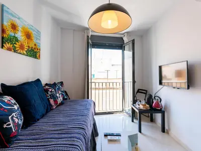a living room with a couch and a window at Apartamento LABORT Apartamento Boutique in Cádiz