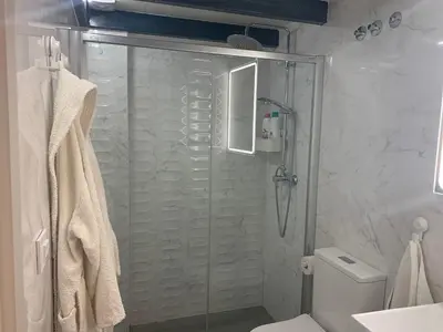 a bathroom with a shower and a toilet at HOLIDAY ALYMA in Sanlúcar de Barrameda