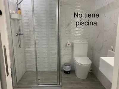 a bathroom with a shower with a toilet and no term pizza at HOLIDAY ALYMA in Sanlúcar de Barrameda