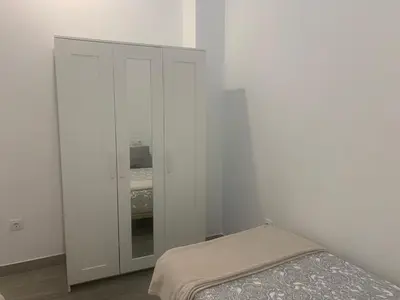 a white bedroom with a bed and a closet at HOLIDAY ALYMA in Sanlúcar de Barrameda