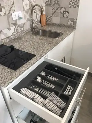 a kitchen with a sink and a drawer with utensils at HOLIDAY ALYMA in Sanlúcar de Barrameda
