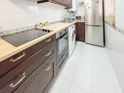 a kitchen with a stainless steel refrigerator and a dishwasher at GuestReady - San Fernando Ronda Estero III in San Fernando