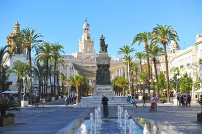 a fountain in a plaza in front of a building at Apartamentos Coralba - El Escondite de la Bahía in San Fernando