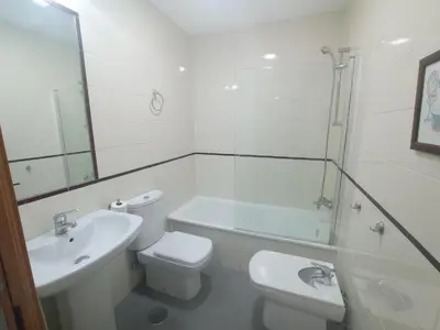 a bathroom with a toilet and a sink and a shower at Apartamentos Coralba - El Escondite de la Bahía in San Fernando