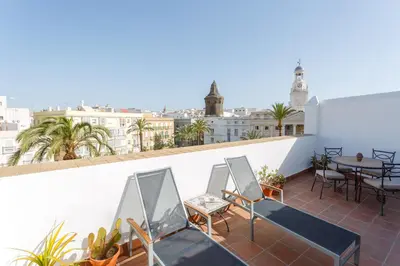 a balcony with chairs and a table on a building at Atico-Solarium CITY Hall by Cadiz4Rentals in Cádiz