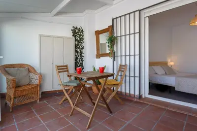 a dining room with a table and chairs and a bed at Atico-Solarium CITY Hall by Cadiz4Rentals in Cádiz