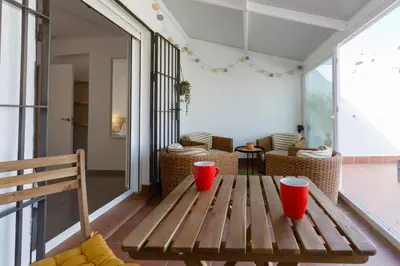 a wooden bench sitting on the porch of a house at Atico-Solarium CITY Hall by Cadiz4Rentals in Cádiz
