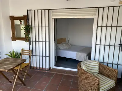 a bedroom with a bed and a table and a chair at Atico-Solarium CITY Hall by Cadiz4Rentals in Cádiz