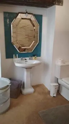 a bathroom with a sink and a mirror on the wall at el rinconcito in Sanlúcar de Barrameda
