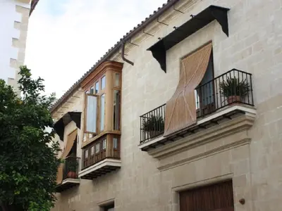 a building with balconies on the side of it at Casa Singular , parking gratis in Jerez de la Frontera