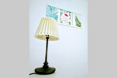 a lamp sitting on a table next to a wall at Central Apartment in Sanlucar in Sanlúcar de Barrameda