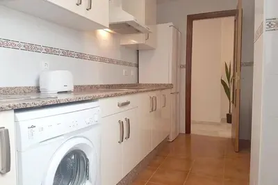 a kitchen with a washer and dryer in a room at Central Apartment in Sanlucar in Sanlúcar de Barrameda