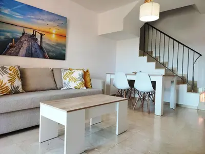 a living room with a couch and a table at ALDEA DEL COTO in Chiclana de la Frontera