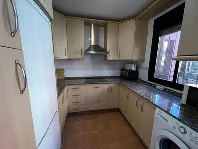 a kitchen with a sink and a stove at ALDEA DEL COTO in Chiclana de la Frontera