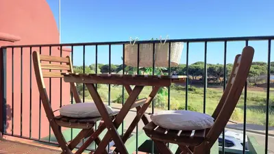 two chairs and a table on a balcony at ALDEA DEL COTO in Chiclana de la Frontera