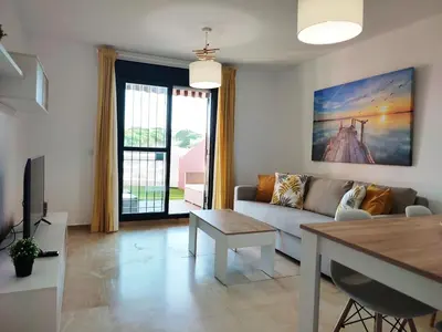 a living room with a couch and a table at ALDEA DEL COTO in Chiclana de la Frontera