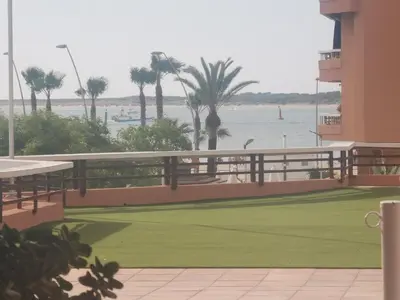 a view of the ocean from the balcony of a hotel at Apartamentos Sanlúcar Beach 4 y 5 in Sanlúcar de Barrameda