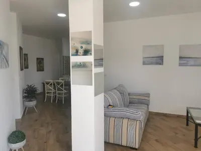 a living room with a couch and a table at Apartamentos Sanlúcar Beach 4 y 5 in Sanlúcar de Barrameda