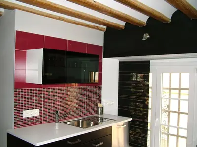 a kitchen with a sink and a red tile wall at Centro Histórico con parking Cádiz in Cádiz