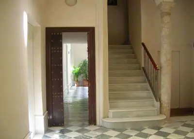 a hallway of a house with stairs and a stair case at Centro Histórico con parking Cádiz in Cádiz