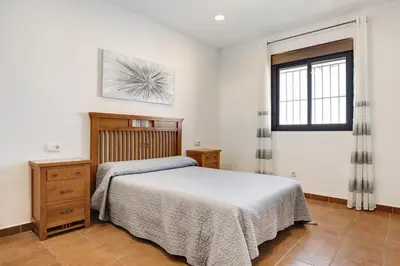 a bedroom with a bed and a window at Vivienda Rural El chiclanero in Conil de la Frontera