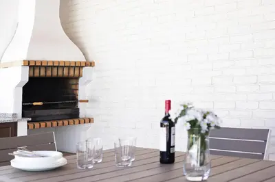 a table with a bottle of wine and glasses at Vivienda Rural El chiclanero in Conil de la Frontera