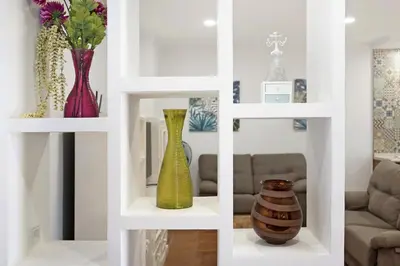 two shelves with vases on them in a living room at Vivienda Rural El chiclanero in Conil de la Frontera