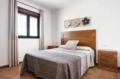 a bedroom with a bed and a window at Vivienda Rural El chiclanero in Conil de la Frontera