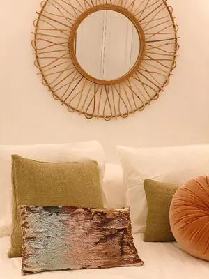 a mirror on the wall above a bed with pillows at SibsSanlucar MARITIMO-1ª Linea de Playa in Sanlúcar de Barrameda