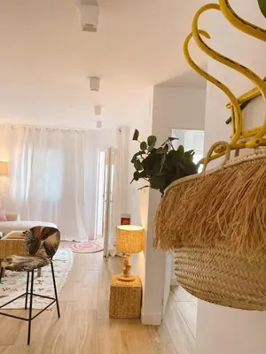 a living room with a chair and a table at SibsSanlucar MARITIMO-1ª Linea de Playa in Sanlúcar de Barrameda