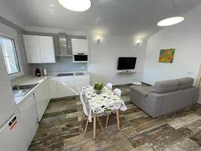 a kitchen and living room with a table and a couch at Casita Rural CONIL in Conil de la Frontera